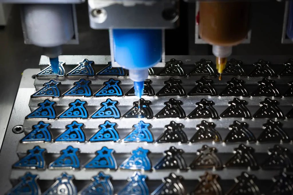 How are enamel pins made?